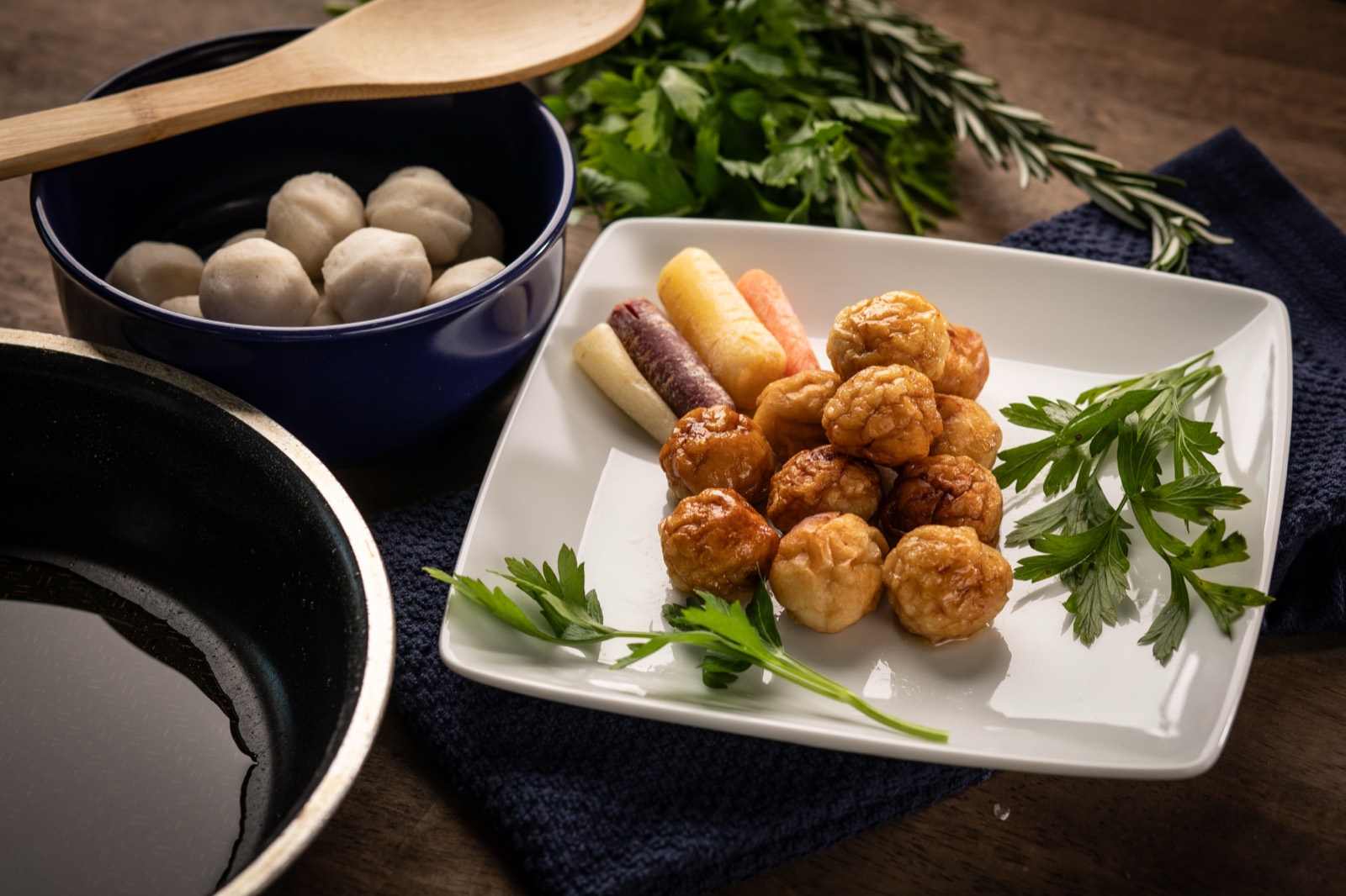 Fish balls and fried fish bites plated with herbs