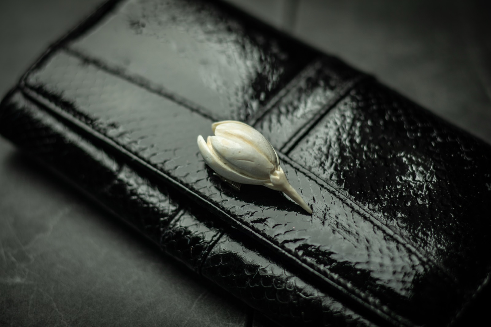 Glossy black fish leather wallet with carved bone flower