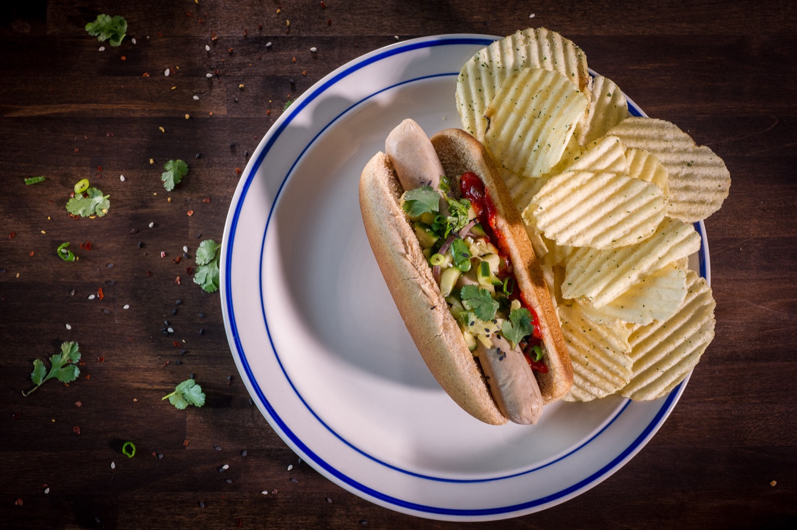 Carp sausage served in a bun with toppings and chips